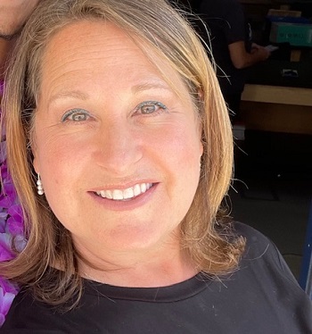 A woman smiles at the camera