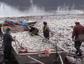 native americans pushing a fishing canoe into the water