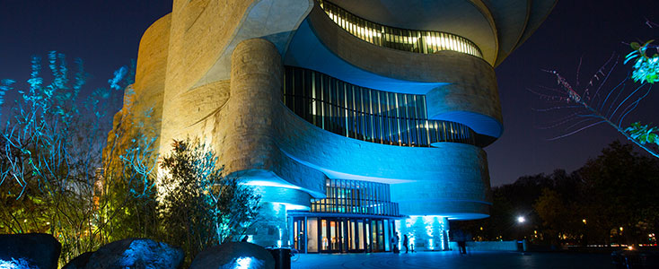 Nighttime view of the NMAI-DC building