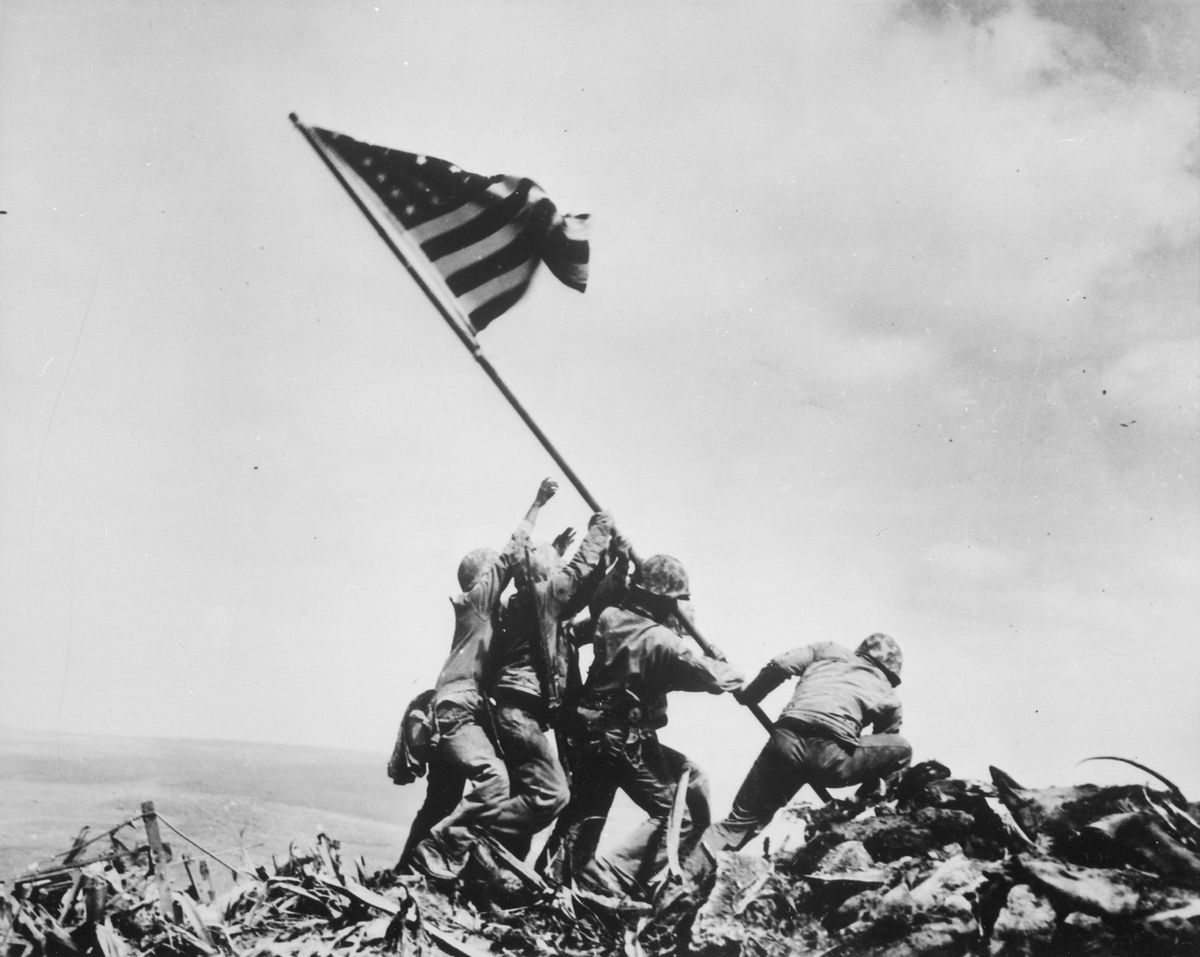 Historic image of five marines and a navy corpsman raising a U.S. flag in Iwo Jima durng World War II