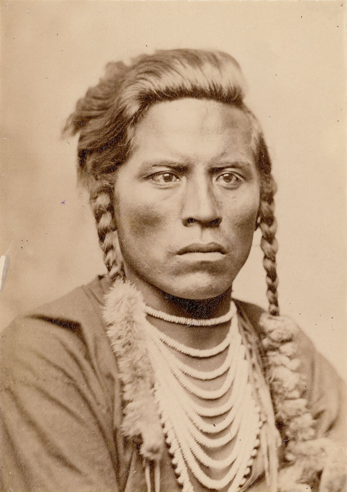 Closeup of Curley, a male American Indian (Crow) military scout in traditional dress