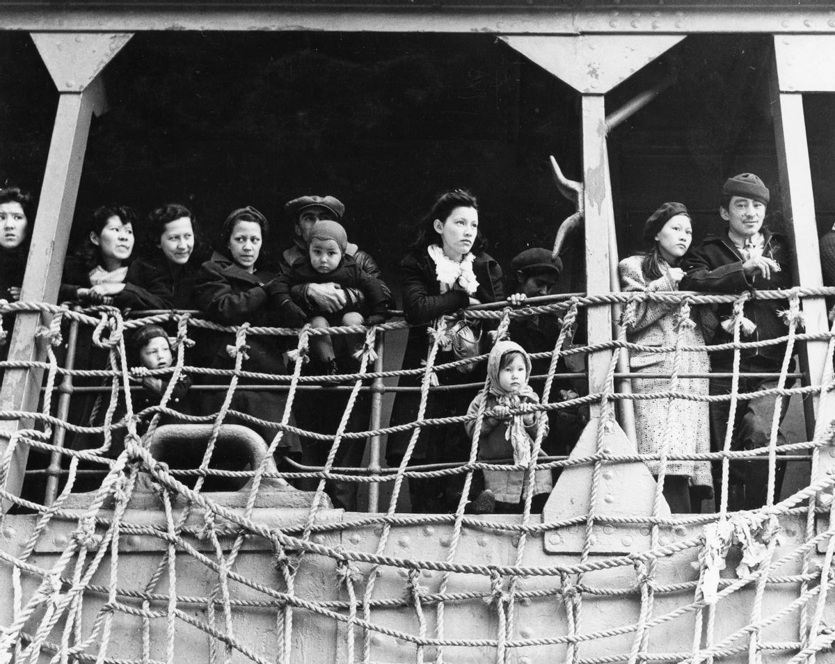 A group of men, women and children aboard the USS Delarok ship looking outward from Alaska’s Pribilof Islands